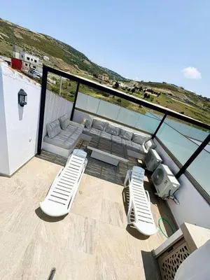 a balcony with a view of the ocean from a house at Maison avec 2 piscines vue mer et montagne in Oulad Akkou