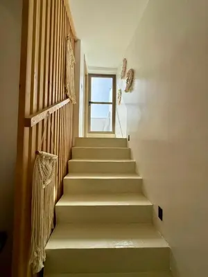 a staircase in a house with a window at Maison avec 2 piscines vue mer et montagne in Oulad Akkou