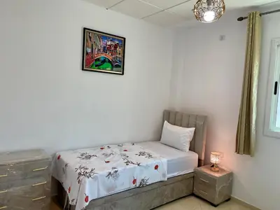 a bedroom with a bed and a picture on the wall at 