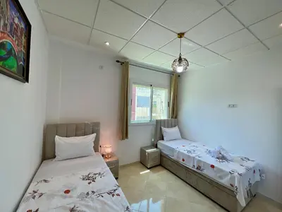 a bedroom with two beds and a window at 