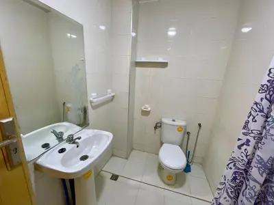 a white bathroom with a sink and a toilet at 