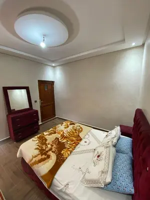 a bedroom with a bed and a couch in a room at Villa cherif in Chouiter