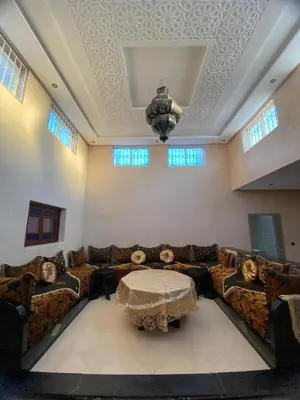 a living room with a couch and a table at Villa cherif in Chouiter