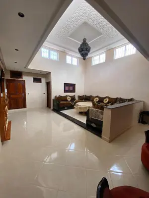 a large living room with couches and a ceiling at Villa cherif in Chouiter
