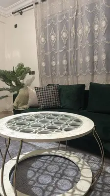 a living room with a coffee table in front of a couch at Appartement BM - Béni Mellal in Beni Mellal