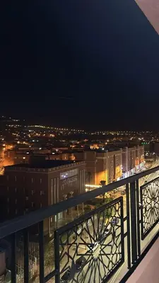 a view of a city at night from a balcony at Appartement BM - Béni Mellal in Beni Mellal