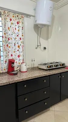 a kitchen with a counter with a stove and a window at Appartement BM - Béni Mellal in Beni Mellal