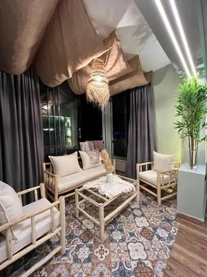 a living room with a couch and chairs and a chandelier at Bella vesta in Oulad Akkou