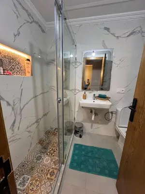 a bathroom with a shower and a sink at Bella vesta in Oulad Akkou