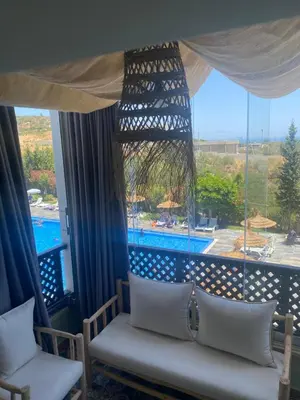 a room with a bed and a large window at Bella vesta in Oulad Akkou