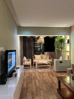 a living room with a couch and a tv at Bella vesta in Oulad Akkou