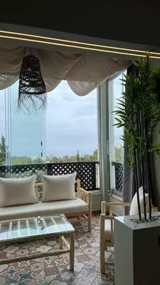 a living room with two white couches and a large window at Bella vesta in Oulad Akkou