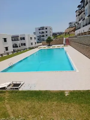 an empty swimming pool in the middle of a building at Bella vesta in Oulad Akkou
