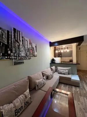 a living room with a couch and a kitchen at Bella vesta in Oulad Akkou
