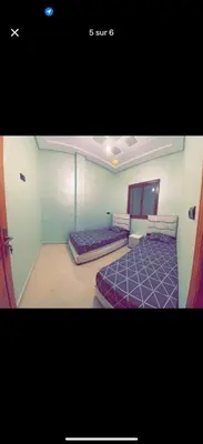 a bedroom with two beds in a room at Apparemment bien entretenu in Meknès