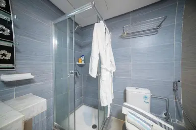 a bathroom with a glass shower and a toilet at Basharly in Oulad Akkou