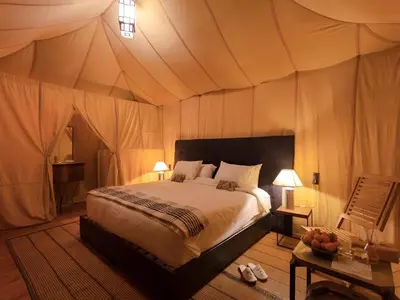 a bedroom with a bed in a tent at Sahara Luxurious Tented in Merzouga