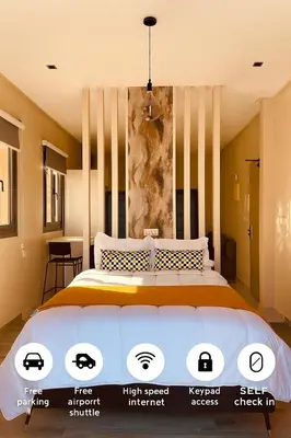 a bedroom with a large bed and a painting on the wall at Relax Family 06 - Cozy Studio in City Center in Ouarzazate