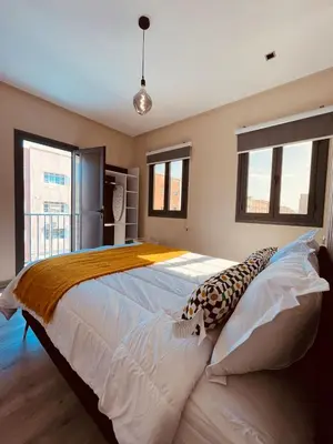 a large bed in a room with windows at Relax Family 06 - Cozy Studio in City Center in Ouarzazate