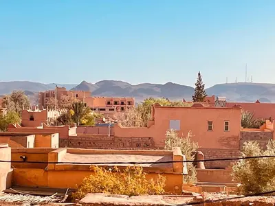 a view of a city with buildings and mountains at Relax Family 06 - Cozy Studio in City Center in Ouarzazate