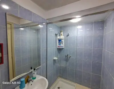 a bathroom with a shower with a sink and a mirror at Maison heureuse Vue magnifique très proche autoroute in Meknès