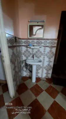 a bathroom with a sink and a mirror at شقق محمد in Oulad Akkou