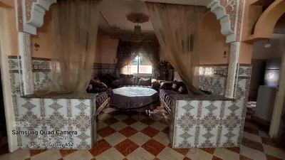 a living room with a couch and a table at شقق محمد in Oulad Akkou