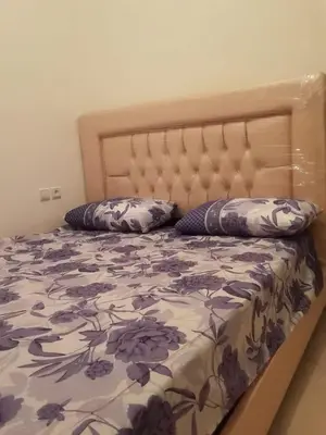 a bed with two pillows on top of it at Alhoceima in Oulad Akkou