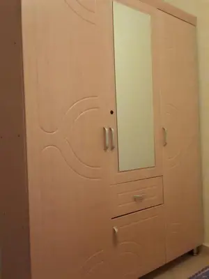 a wooden cabinet with a mirror on top of it at Alhoceima in Oulad Akkou