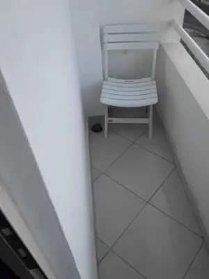 a white chair sitting in the middle of a staircase at Alhoceima in Oulad Akkou