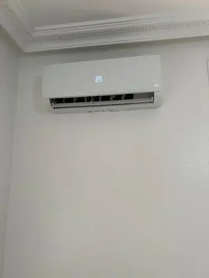 a wall mounted air conditioner on a white wall at Résidence badr in Oulad Akkou