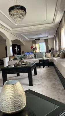 a living room with a couch and a table at Palm in Oulad Akkou