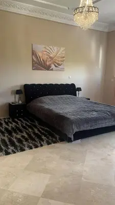 a bedroom with a large bed in a room at Palm in Oulad Akkou