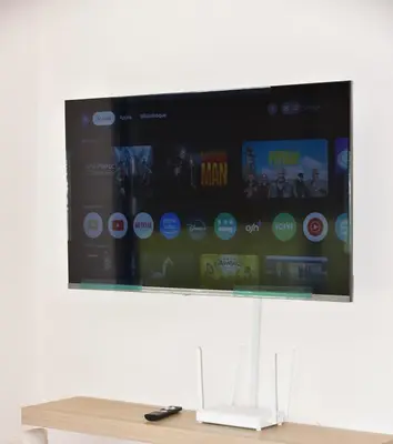 a flat screen tv hanging on a wall at Mehdia Beach in Oulad Akkou