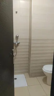 a bathroom with a shower with a toilet at Jardin Ifrane Perle in Oulad Akkou