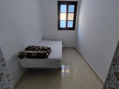 a small room with a bed and a window at شقة وسط المدينة in Oulad Akkou