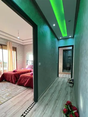 a room with a bed and a green wall at Ourika Luxury Villa in Ourika