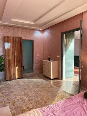 a bedroom with a large bed and a dresser at Ourika Luxury Villa in Ourika