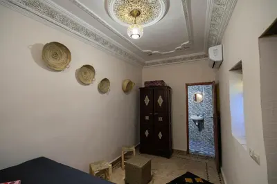 a room with a ceiling with a chandelier at Riad Fez Unique in Fès