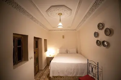 a bedroom with a bed and plates on the wall at Riad Fez Unique in Fès