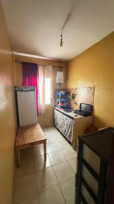 a kitchen with a counter and a table in a room at Elmaghouss in Oulad Akkou