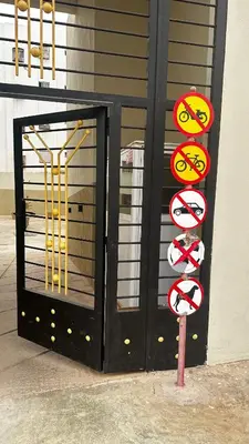 a black door with signs in front of a building at Elmaghouss in Oulad Akkou