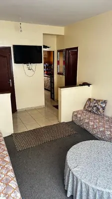 a living room with a couch and a flat screen tv at Elmaghouss in Oulad Akkou
