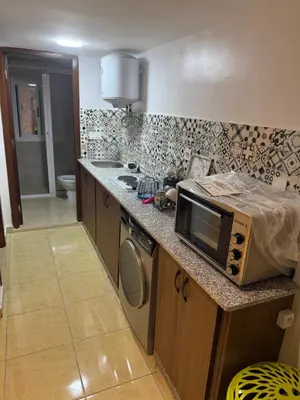 a kitchen with a microwave sitting on a counter at Descanso ideal en Nador in Oulad Akkou