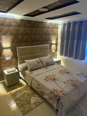 a bedroom with a large bed with a flower design on it at Descanso ideal en Nador in Oulad Akkou