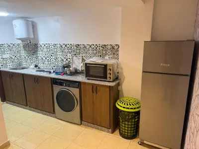 a kitchen with a microwave and a refrigerator at Descanso ideal en Nador in Oulad Akkou