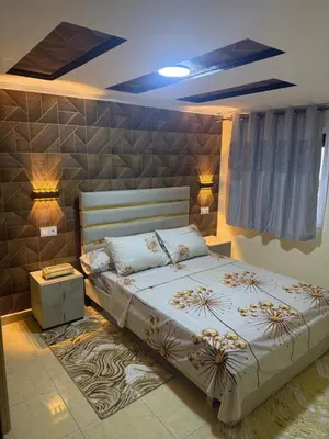 a bedroom with a large bed and two lamps at Descanso ideal en Nador in Oulad Akkou