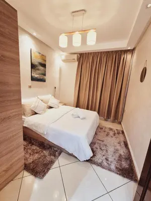 a bedroom with a white bed and a window at Bright & Comfortable Marrakech Duplex in Oulad Akkou