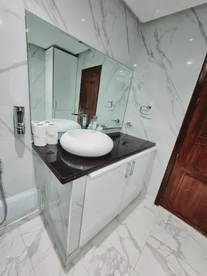 a bathroom with a sink and a mirror at Bright & Comfortable Marrakech Duplex in Oulad Akkou