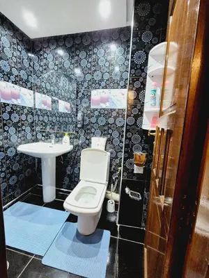 a small bathroom with a toilet and a sink at Bright & Comfortable Marrakech Duplex in Oulad Akkou